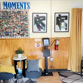 A cozy and inviting lobby, complete with comfortable seating and a colorful bulletin board showcasing heartwarming moments from our daycare. It’s the perfect space for families to feel welcomed and connected.