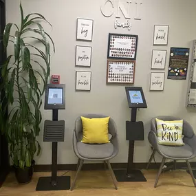 A cozy and inviting lobby, complete with comfortable seating and a colorful bulletin board showcasing heartwarming moments from our daycare. It’s the perfect space for families to feel welcomed and connected.