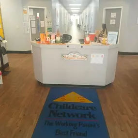 A cozy and inviting lobby, complete with comfortable seating and a colorful bulletin board showcasing heartwarming moments from our daycare. It’s the perfect space for families to feel welcomed and connected.