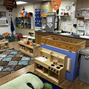 A warm, nurturing space where babies can explore safely, with soft play areas, age-appropriate toys, and attentive caregivers supporting their early development.