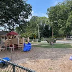 A spacious playground filled with colorful play structures, perfect for adventure and exploration.
