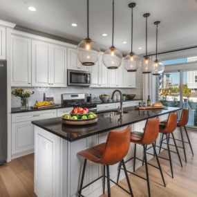 Gorgeous kitchens with large center islands, brand-name stainless steel appliances, and granite countertops