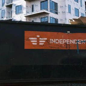 Independent Waste rental dumpster in front of construction