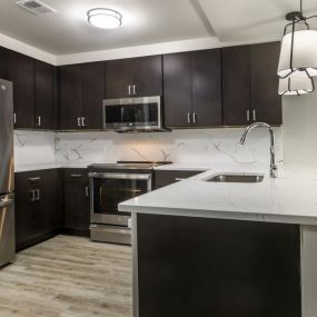 Robust wood cabinetry, granite countertops and  with stainless steel appliances.