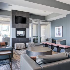 Lounge seating with charging stations and entertainment room.