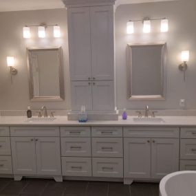 We worked on this bathroom in 2022. This clean look features brushed nickel faucets and sconces along with lots of storage for both him and her.