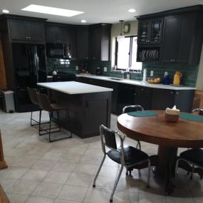 This 2020 kitchen remodel features some really slick black cabinets, with white countertops. I particularly liked the green back-splash. See more examples of our work at our website.