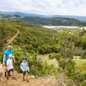 Family hikes on a mountain, like activities found near new construction homes in Heber City, Utah