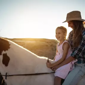 Mother and daughter ride a horse, like activities found near new construction in Heber City, Utah