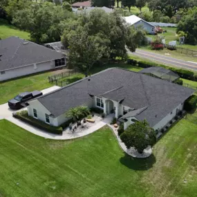 “Aerial view of a completed roofing project by Armor Roofing FL in Leesburg, Florida, featuring a modern asphalt shingle roof on a single-story residential home — showcasing the work of professional roofers in Leesburg.