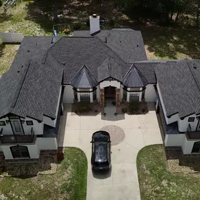 Full aerial shot of luxury home with architectural shingle and black metal roofing by Armor Roofing and Home Improvement—reliable roofers in Leesburg specializing in premium residential roofing systems.