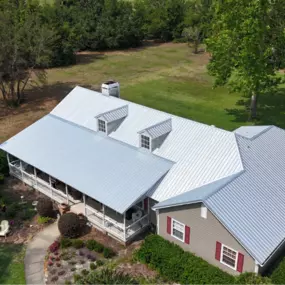 Completed metal roof installation on residential home by Armor Roofing FL, showcasing recent roofing project with durable, energy-efficient materials.