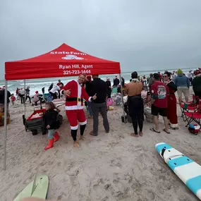 Had the privilege of handing out coffee and donuts to the surfers and surfing Santa! - Ryan Hill State Farm Insurance Agent Palm Bay call for a free quote