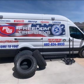 Freedom Tire Guys Arizona mobile truck with new tires outside of mobile van