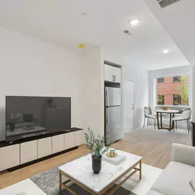 The Gio Apartments showcase an open-concept living, kitchen, and dining area with sleek modern design.