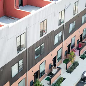 A top-down exterior view of The Gio Apartments highlights the building’s modern architecture and urban setting.