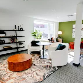 A modern and stylishly decorated common area at The Gio with a mix of seating options.