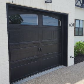 Here is a black single car carriage style garage door with arched windows that we recently installed.