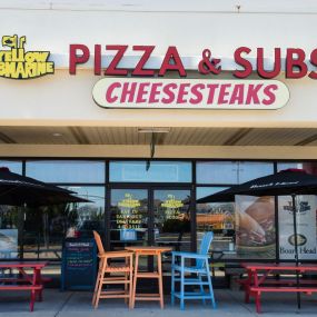 Yellow Submarine Pizza & Subs & Cheesesteaks Storefront with outdoor seating at the Outer Banks Mall in Nags Head, North Carolina.