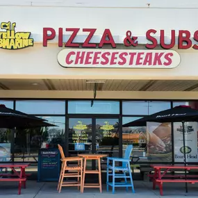 Yellow Submarine Pizza & Subs & Cheesesteaks Storefront with outdoor seating at the Outer Banks Mall in Nags Head, North Carolina.