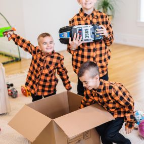 kids playing with a CT Moving and Storage box