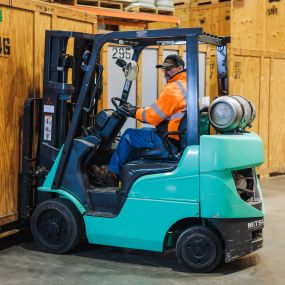 CT Moving and Storage team member operating a fork lift