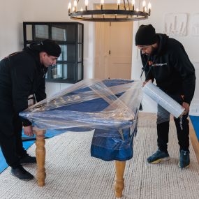 CT Moving and Storage team wrapping a table