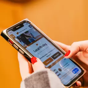 A customer browses the CT Moving and Storage website on their smartphone.