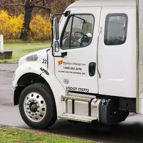 A close-up of a CT Moving and Storage truck, showcasing company branding and contact information.