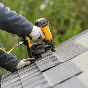 Roofer Installing Asphalt Shingles on Roof