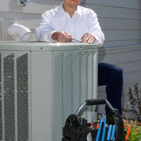 HVAC Technician Performing Air Conditioner Maintenance Services