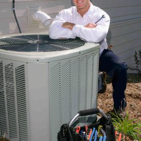 HVAC Technician Performing Maintenance Services on a Carrier Outdoor Air Conditioning Unit
