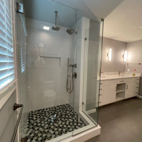 Primary bathroom with custom shower, vanities, and lighting