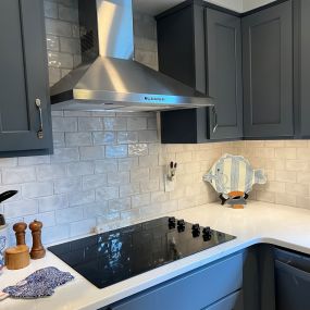 Kitchen remodel showing hood and backsplash