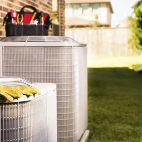 An air conditioning system installed on the side of a residential home. The unit is positioned neatly and securely, with proper spacing for ventilation. The system appears well-maintained, with no visible signs of damage. Its location suggests efficient cooling for the home, blending seamlessly with the exterior design.