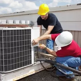 Two HVAC contractors are seen performing routine annual maintenance on a commercial HVAC unit. They are inspecting the unit, cleaning components, and ensuring its optimal performance. Their professional demeanor and attention to detail highlight the importance of regular maintenance for commercial HVAC systems.