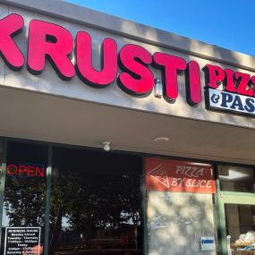 Krusti Pizza and Pasta Storefront Signage, daytime