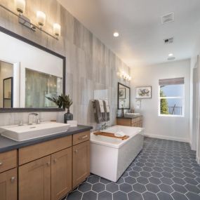 Luxurious primary bathrooms with large walk-in shower with tile surround