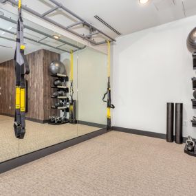 Resident gym with weight and mirrored walls