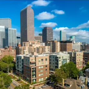 Denver skyline showing the apartment building on a sunny day with blue sky and white clouds