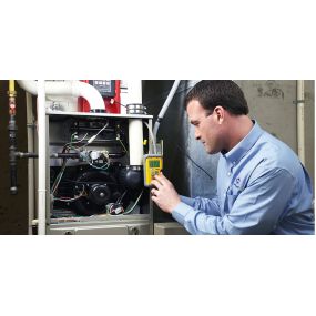 An HVAC contractor is shown conducting a routine check-up on an HVAC system using a multimeter. This maintenance procedure helps ensure the system operates efficiently and effectively. By inspecting electrical components, the contractor can detect and resolve any issues, ensuring the HVAC system continues to provide reliable comfort.