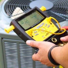 Expert maintenance in action! Our HVAC contractors in Athens, GA use precise tools like multimeters to keep your HVAC system running smoothly. Regular maintenance ensures peak performance and efficiency.