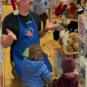 Christian showing this adorable little audience the magic of Dino hand puppets—this is the kind of joy you can only find in a true toy store!! ✨ #shopsmall