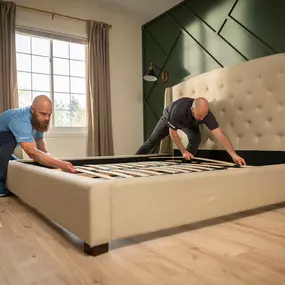 Moving crew setting up bed