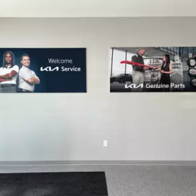Interior signage at Jeff Wyler Kia of Colerain showing the Parts and Service Departments, guiding customers to OEM Kia parts, accessories, and certified vehicle maintenance and repair services in Colerain near Cincinnati.