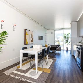 Modern Kitchen with access to the living room, dining area, and patio door.