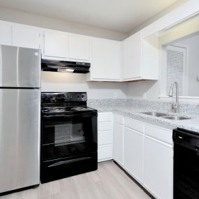 renovated kitchen with quartz counters and white cabinets