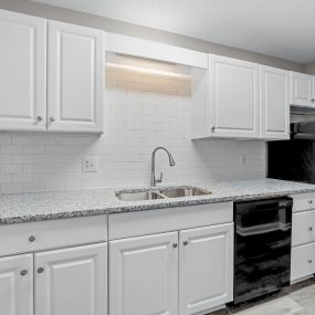 renovated kitchen with quartz counters and white cabinets