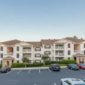 View of the apartment building with parking spaces