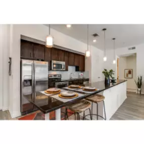 Kitchen view with stainless steel appliances and open spacing floorplan.